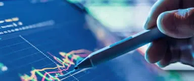 Hand with stylus analyzing market data, representing StoneX Pro's bespoke liquidity solutions.