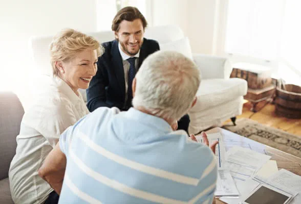 Senior couple consulting with a wealth advisor, representing StoneX Wealth Management’s personalized investment advisory services