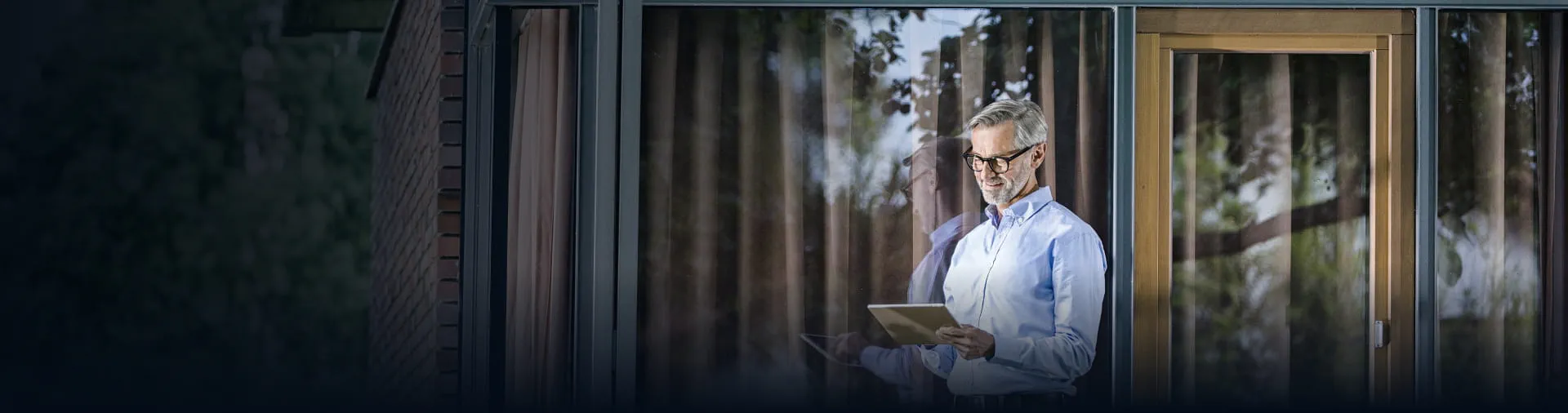 Professional using a tablet outdoors, representing StoneX Wealth Management's platform tools and resources for navigating today's market