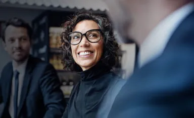 Woman with glasses and a man discussing institutional-grade clearing and custody services