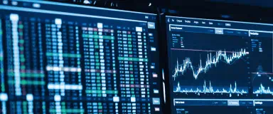 Trading screens displaying market data, representing StoneX Pro's end-to-end execution services.