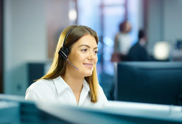 Support team member with a headset, emphasizing StoneX Wealth Management's 24/7 technology support and dedicated regional services