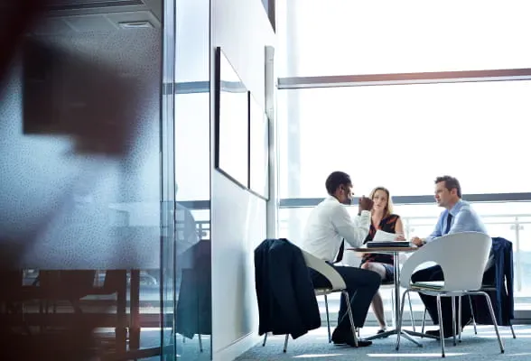 Three professionals in discussion, highlighting StoneX Wealth Management's support for practice management, acquisitions, and succession planning
