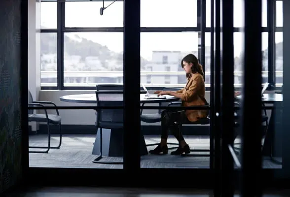 Financial professional working in a conference room, illustrating StoneX Wealth Management's flexible affiliation options for advisors