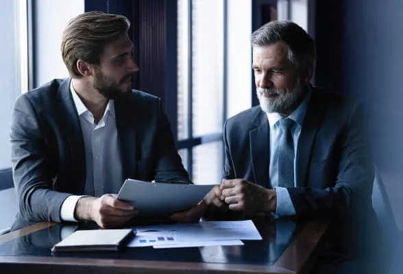 Two men in discussion, emphasizing StoneX Wealth Management's mission to provide tailored support and resources to meet financial goals