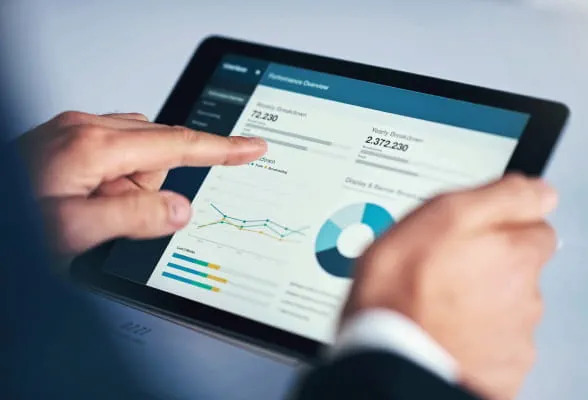 Tablet displaying financial data and charts, representing tax strategies and resources for managing tax-efficient investing and preparation