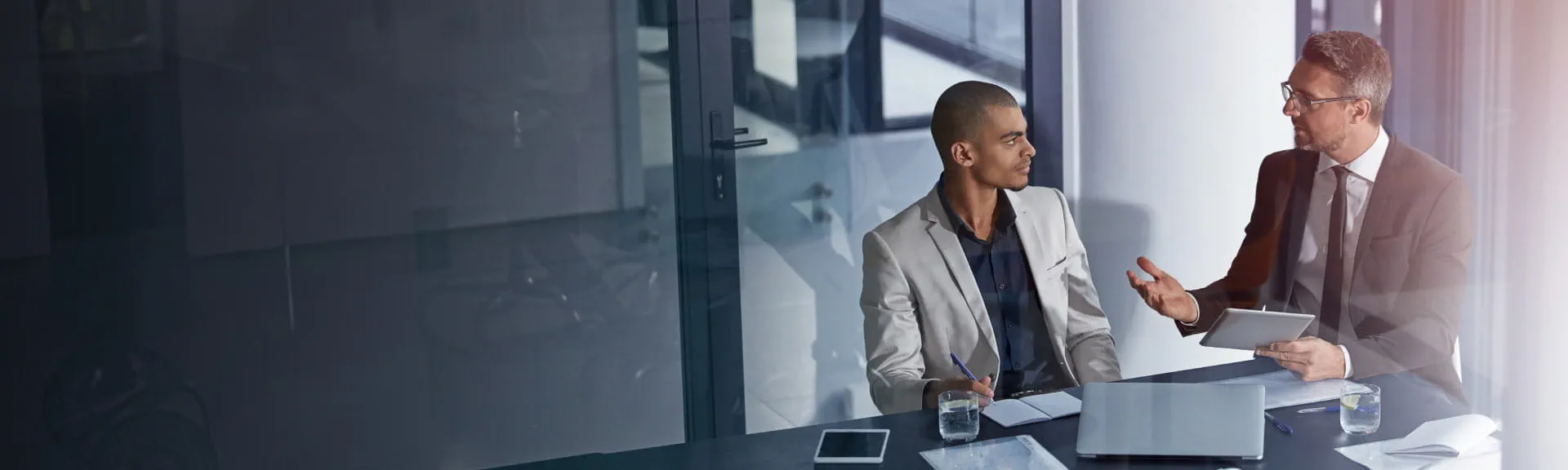 Two financial professionals in a discussion, highlighting StoneX Wealth Management's commitment to empowering financial advisors with innovation